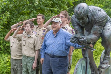 Dave Alexander, right, celebrates the unveiling of a bronze in his honor at Dave Alexander Low Gear.