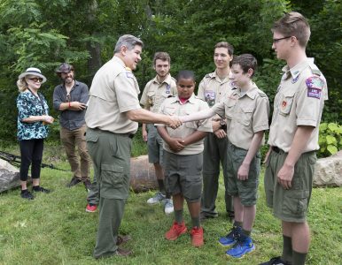 JIm Turley interacts with Scouts at the 2017 National Scout Jamboree during the unveiling ceremony for the Dave Alexander bronze.
