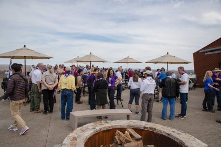 Representatives from the 2019 World Scout Jamboree team mingle on the deck and patio at WP Point.