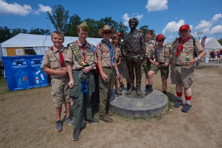Scouts pose with the bronze statue of Stephen Marriott, son of J.W. Marriott Jr., at the Summit Bechtel Reserve.