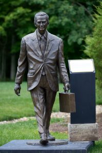 The bronze statue depicting J.W. Marriott Jr. with his trademark briefcase stands near J.W. Marriott, Jr. Leadership Center.