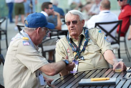 Summit Bechtel Reserve philanthropists Wayne Perry, left, and Lonnie Poole enjoy conversation on the patio at WP Point during the 2019 World Scout Jamboree.