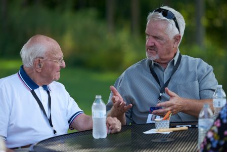 Summit Bechtel Reserve philanthropists Paul Christen, left, and Brett Harvey enjoy dinner conversation on the patio at WP Point during the 2019 World Scout Jamboree.