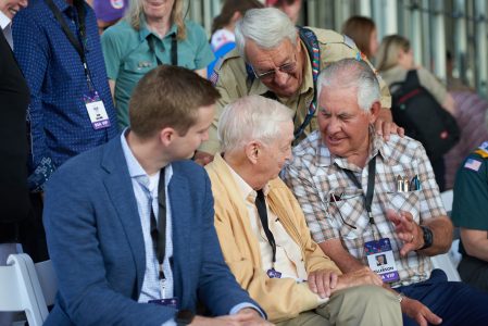 Front from left, Blake Marriott, J.W. Marriott Jr., and Rex Tillerson, as well as Lonnie Poole, back, enjoy conversation before the construction celebration for the J.W. Marriott, Jr. Leadership Center at the 2019 World Scout Jamboree.