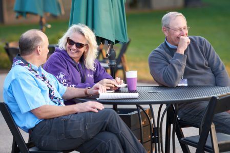 Mary Fenneman, center, and Craig Fenneman, right, enjoy conversation on the deck at WP Point.