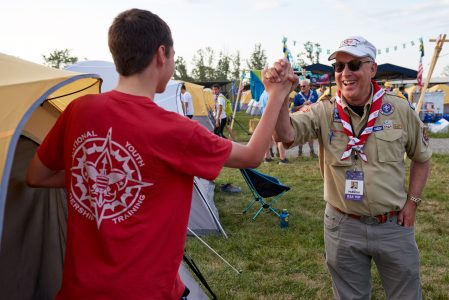 Doyle Parrish, left, visits with Scouts during the 2019 World Scout Jamboree.
