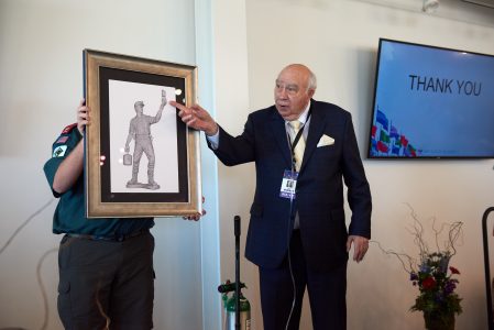 Robert Murray explains the symbolism and details in the "Shepherd of the Flock" bronze sketch during the 2019 World Scout Jamboree, where the bronze was unveiled.