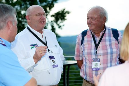 Summit Bechtel Reserve philanthropists Ray Dillon, left, and Doug Dittrick enjoy conversation on the deck at WP Point during the 2019 World Scout Jamboree.