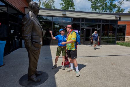 International Scouts admire the bronze statue depicting Rex Tillerson in the courtyard of the Rex W. Tillerson Leadership Center during the 2019 World Scout Jamboree.