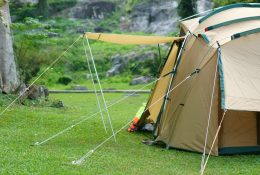 camping tent on waterfall and stream with tree in green jungle or forest for summer winter holiday relax and vacation travel trip with trekking and picnic on lawn or grass at Khlong Nam Lai Waterfall