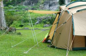 camping tent on waterfall and stream with tree in green jungle or forest for summer winter holiday relax and vacation travel trip with trekking and picnic on lawn or grass at Khlong Nam Lai Waterfall