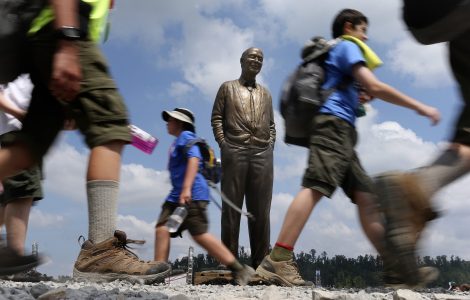 Scouts walk past the statue of Steve Bechtel near the AT&T Summit Stadium during the 2013 National Scout Jamboree on July 17, 2013. (Photo by Tom Copeland)