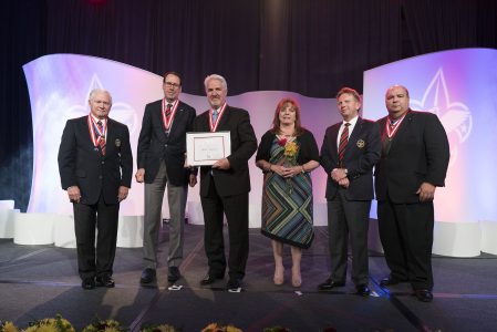 Brett Harvey, second from left, and wife Carol, third from left, accept the Silver Buffalo Award along with Robert Gates, Randall Stephenson, then-Chief Scout Executive Mike Surbaugh, and Tico Perez.