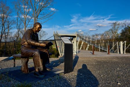 At the base of the CONSOL Energy Bridge is a bronze statue depicting Paul Christen reading the page of the Boy Scout Handbook that helped him survive a real-life tragedy.