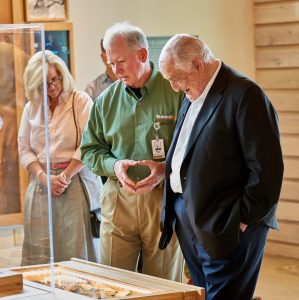 Walter Scott, right, reviews some of the Scouting memorabilia on display within Scott Visitor Center.