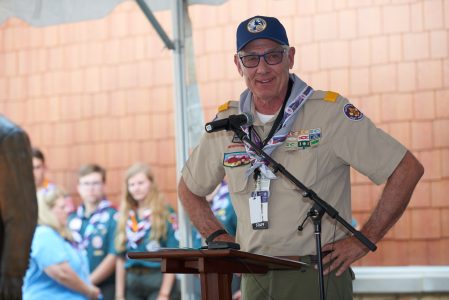 Past BSA National President Wayne Perry explains the significance of a world-class leadership center during the dedication of Rex W. Tillerson Leadership Center at the 2019 World Scout Jamboree.