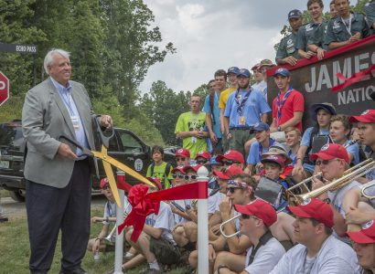 West Virginia Gov. Jim Justice cuts the ribbon to dedicate James C. Justice National Scout Camp, surrounded by Scouts at the 2017 National Scout Jamboree.