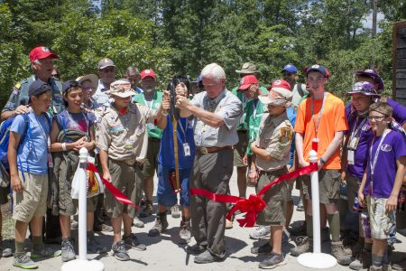 Frank McAllister, center, cuts the ribbon to dedicate McAllister Family Sustainability Challenge Trail with a few of his Scouting friends at the 2017 National Scout Jamboree.
