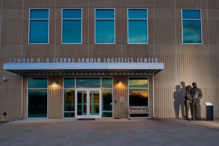 A bronze statue of Ed and Jeanne Arnold welcomes visitors and staff to the Edward H. and Jeanne Arnold Logistics Center.